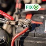 Close-up view of a loose car battery terminal connection with red and black cables, labeled for identification and showing a fix indicator.
