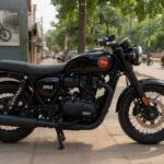 Black BSA motorcycle with matte finish and red logo parked on a city sidewalk, with pedestrians, trees, and motorcycles in the background.