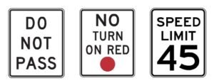 Three rectangular white road signs with black text: “DO NOT PASS,” “NO TURN ON RED” with a red dot, and “SPEED LIMIT 45,” all indicating legally enforceable traffic rules that drivers must follow.