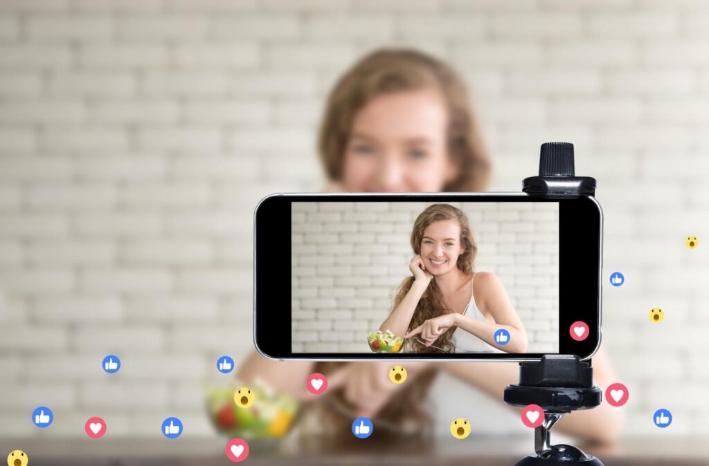 Content creator using smartphone to film videos demonstrating AI influencer generators technology with social media engagement icons