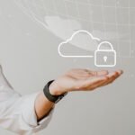 Professional person in white shirt holding hand out with digital cloud and security lock icon floating above palm, representing secure cloud proxy services