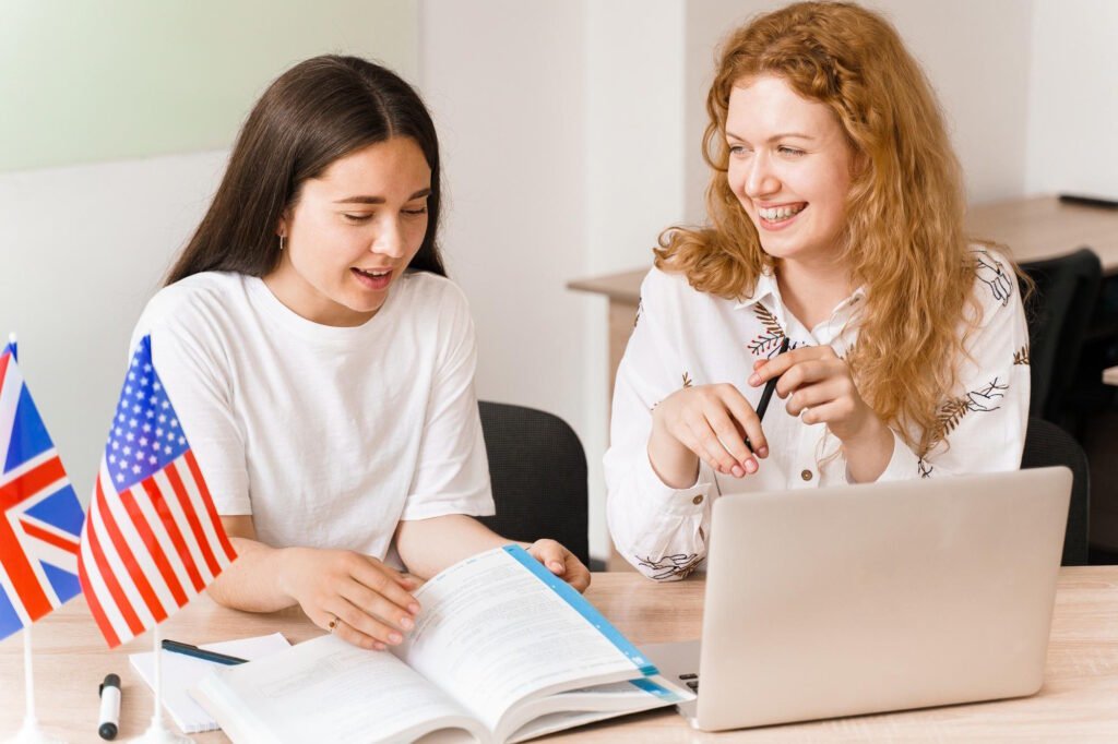 Students learning English online with books, laptop and language level indicators A1 through B2.