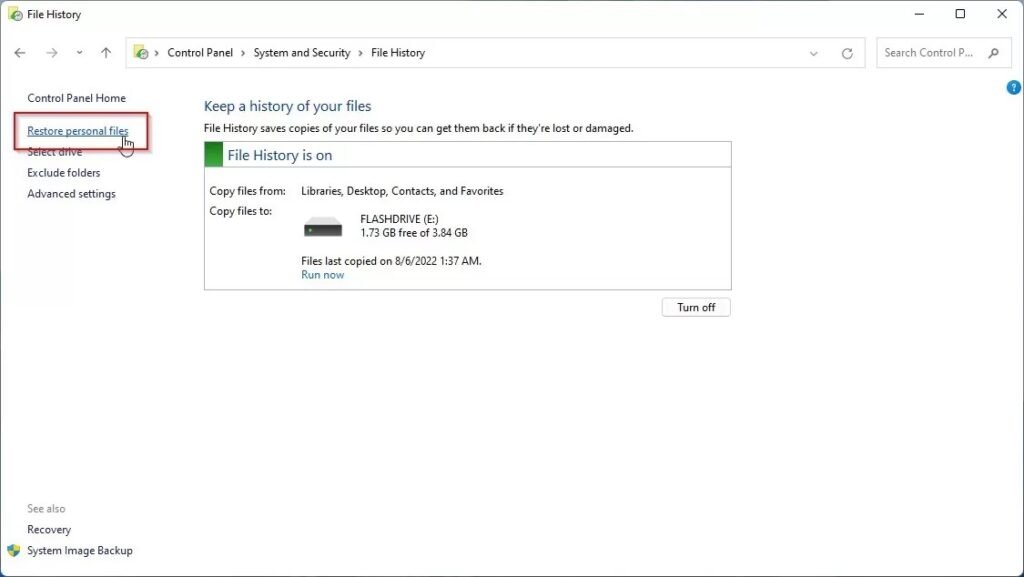 Windows File History Control Panel showing the main interface with 'Restore personal files' option highlighted in red box on the left sidebar. The main panel displays File History status as 'on', copying files from Libraries, Desktop, Contacts, and Favorites to a FLASHDRIVE with last backup on 8/6/2022 at 1:37 AM.