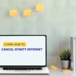 Laptop on a desk displaying “Learn How to Cancel Xfinity Internet” with office supplies and sticky notes in the background.