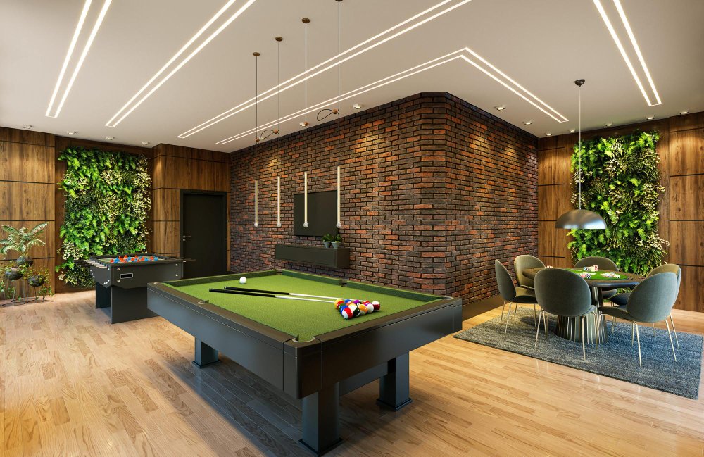 Modern luxury game room featuring a sleek black pool table with green felt, exposed brick accent wall, LED strip ceiling lighting, living plant walls, wooden paneling, and contemporary dining area with gray chairs